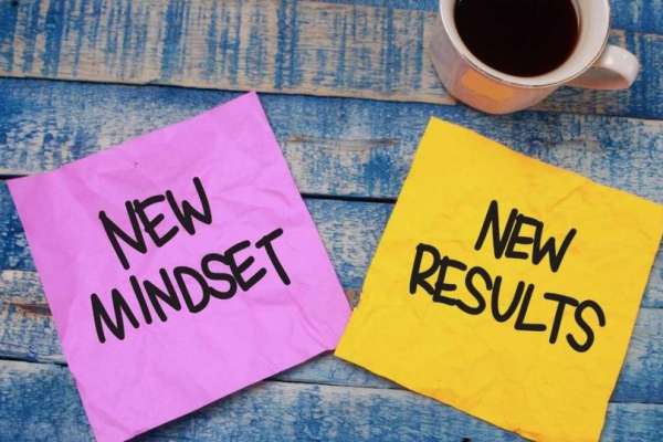 Two sticky notes saying new mindset and new results